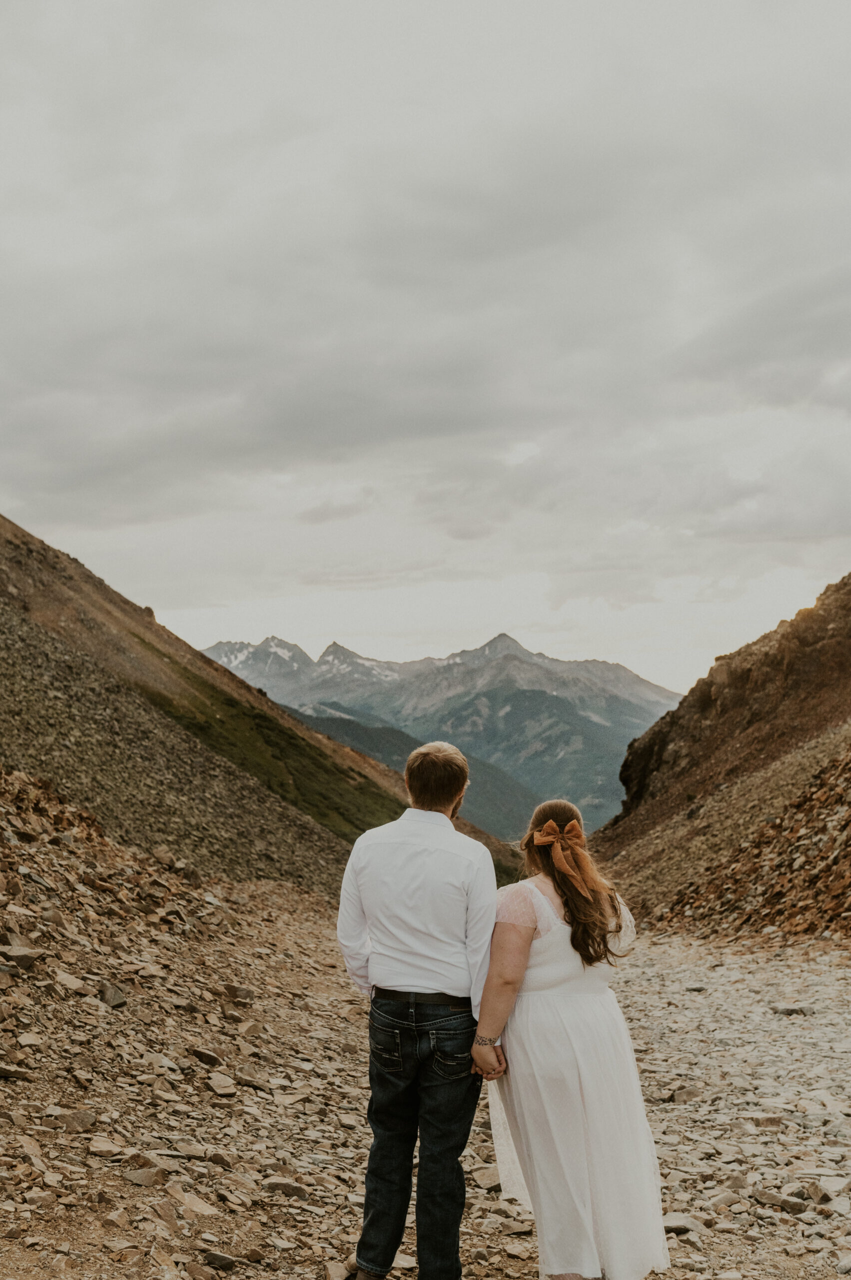 Couple looks out at the mountains during their Ophir pass off-roading engagement session.