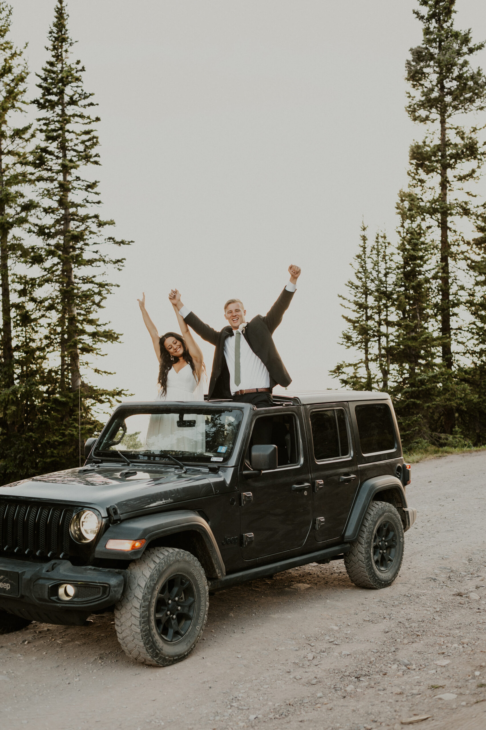 A couple cheering during their jeeping elopement in Crested Butte, Colorado