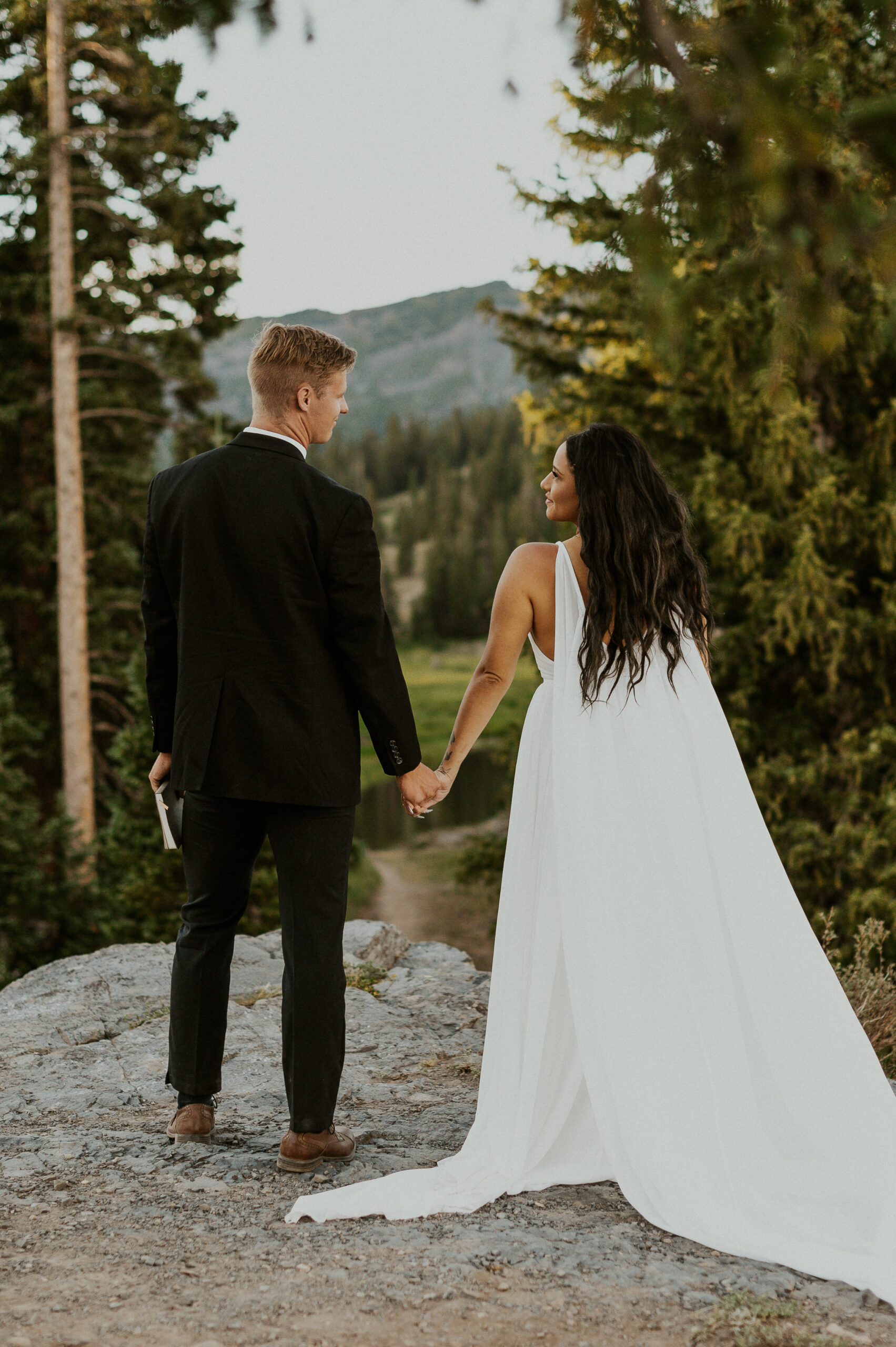 Couple holding hands and looking at the views during their Crested Butte elopement.