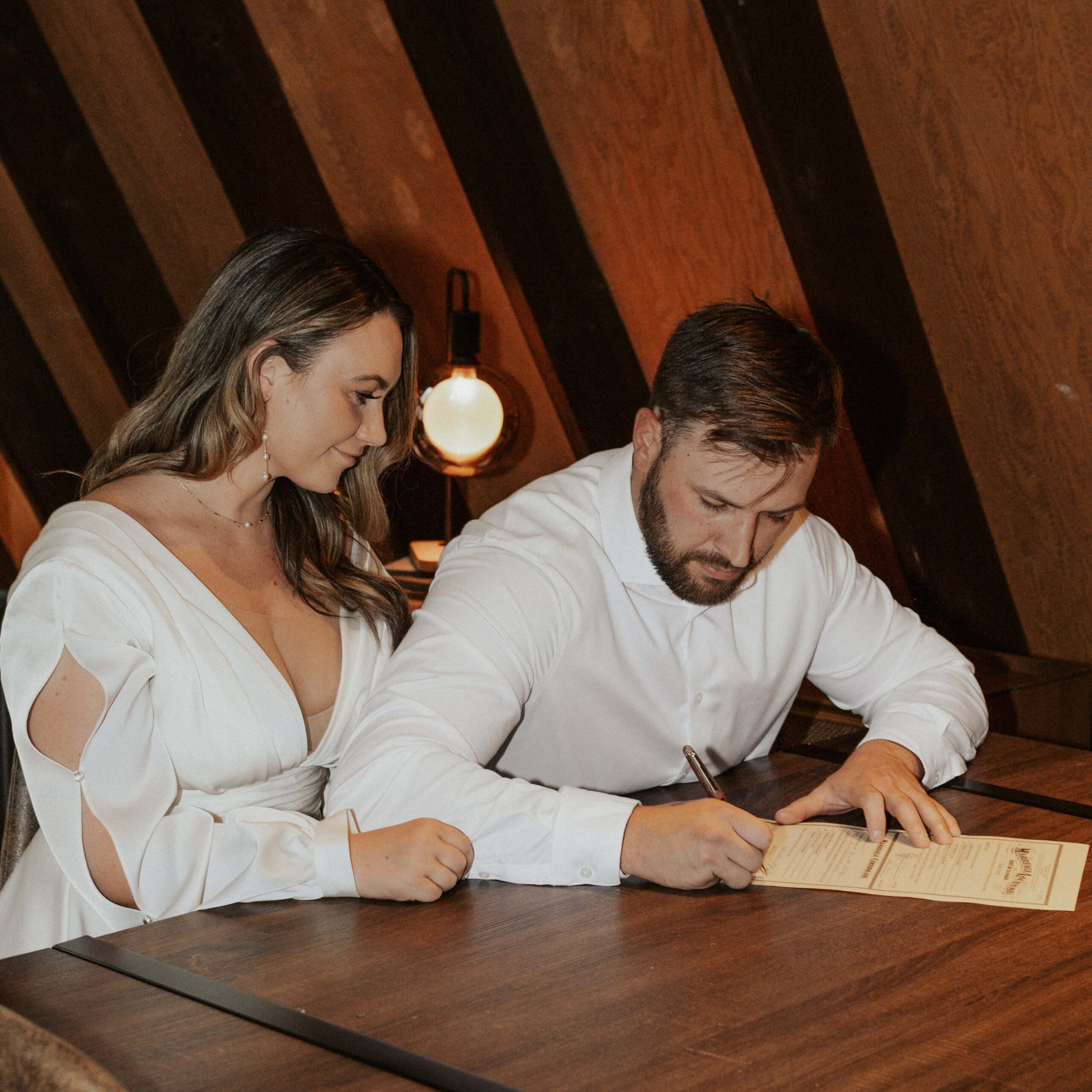 Couple signing their Colorado marriage license before their winter elopement in Breckenridge. 