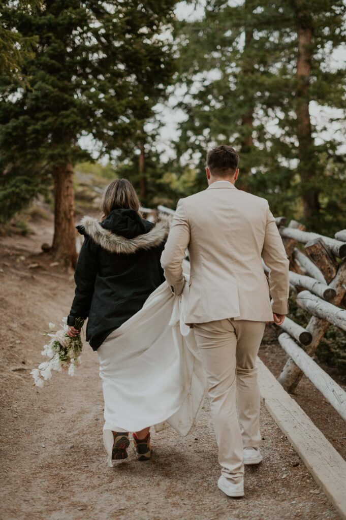 Couple hiking a trail during their late March winter elopement in Colorado.