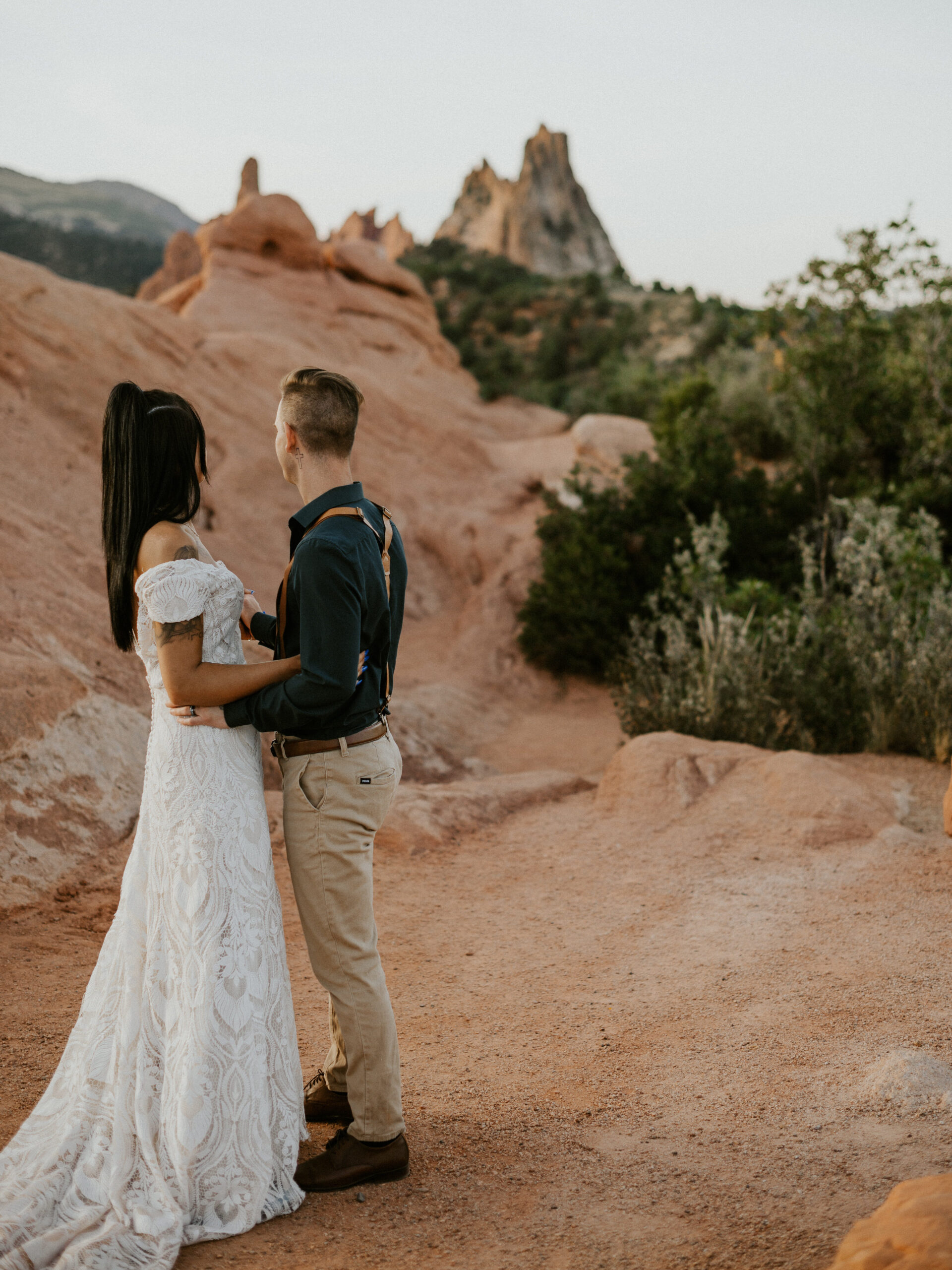 Couple looking out at the landscape of red rocks during their winter elopement at Garden of the Gods, Colorado. 