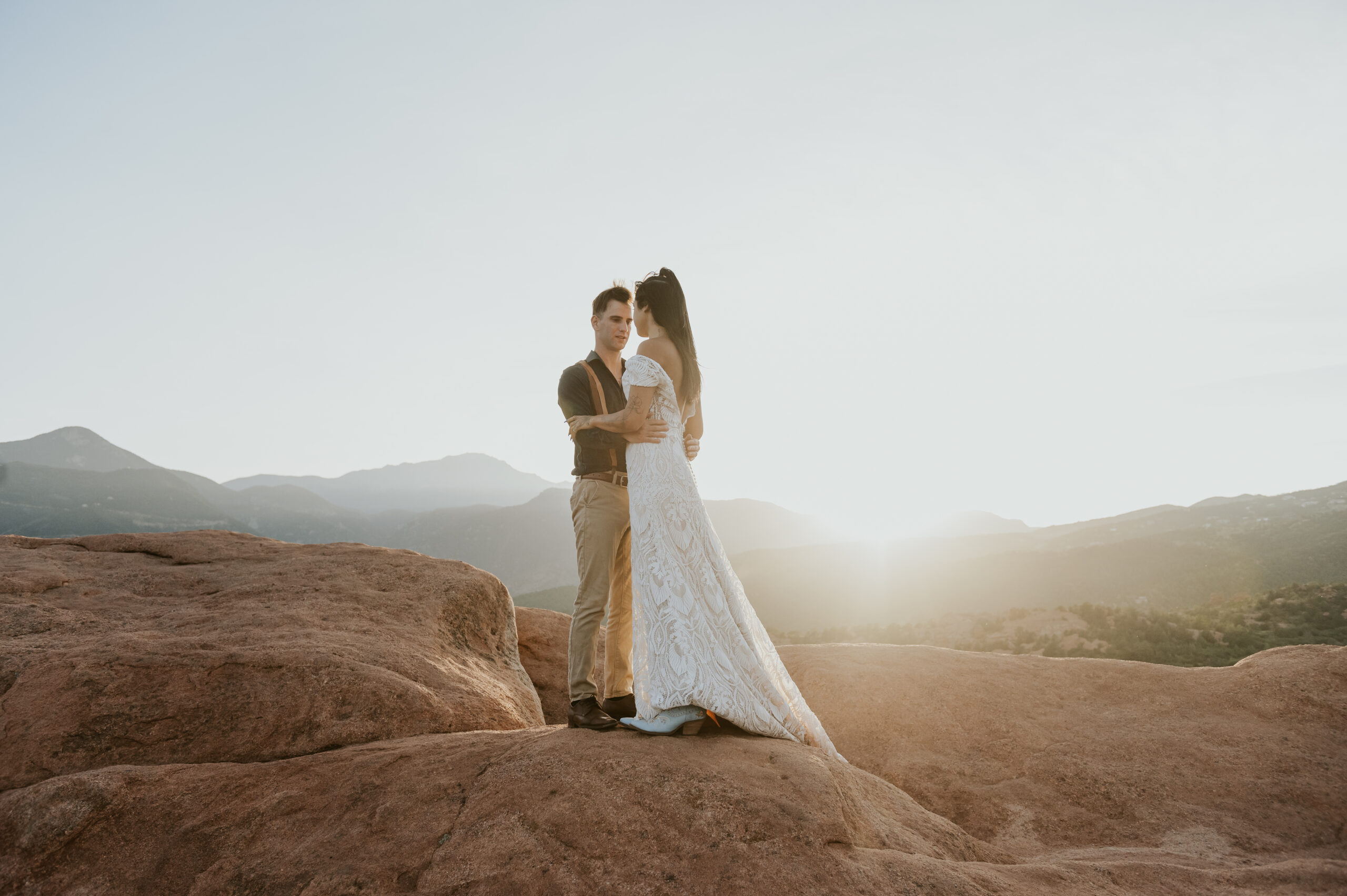 Couple embracing as the sun sets on their winter elopement. 