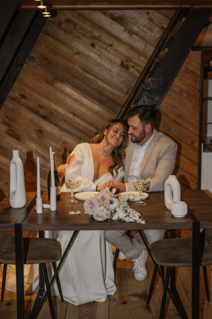 Couple embracing each other after their elopement dinner at their Airbnb during their winter elopement in Breckenridge, Colorado. 