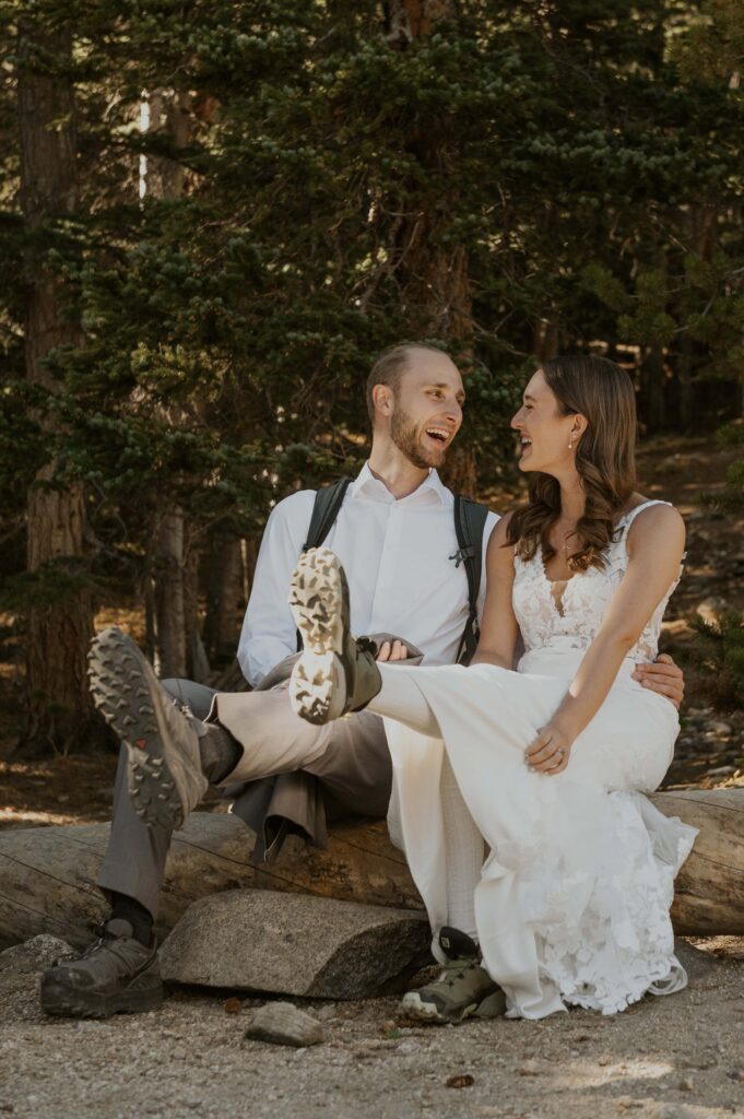 Couple showing off their winter elopement hiking boots on a trail in Colorado.