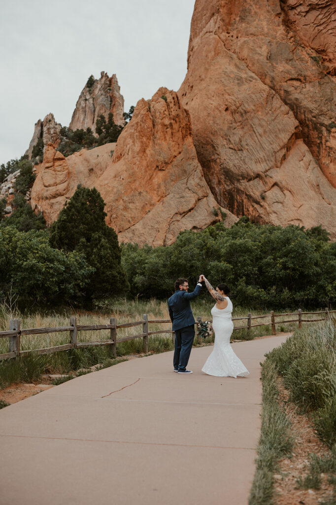 Couple in wedding attire having their first dance in the Central Garden of Garden of the Gods.