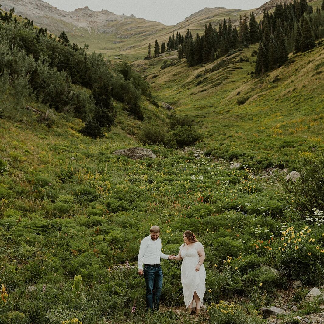 Couple exploring the wildflowers and mountains in Ouray, Colorado.