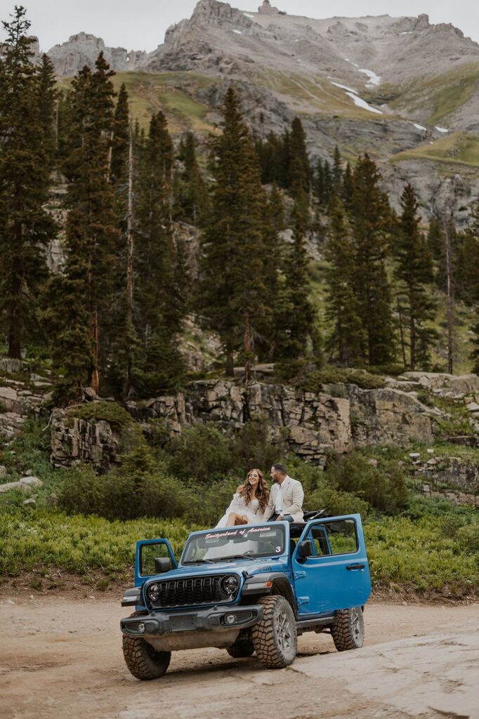 Couple talking on the roof of a jeep in Yankee Boy Basin.