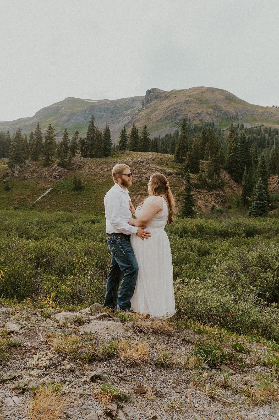 Couple holding each other close in the San Juan Mountains after exploring.