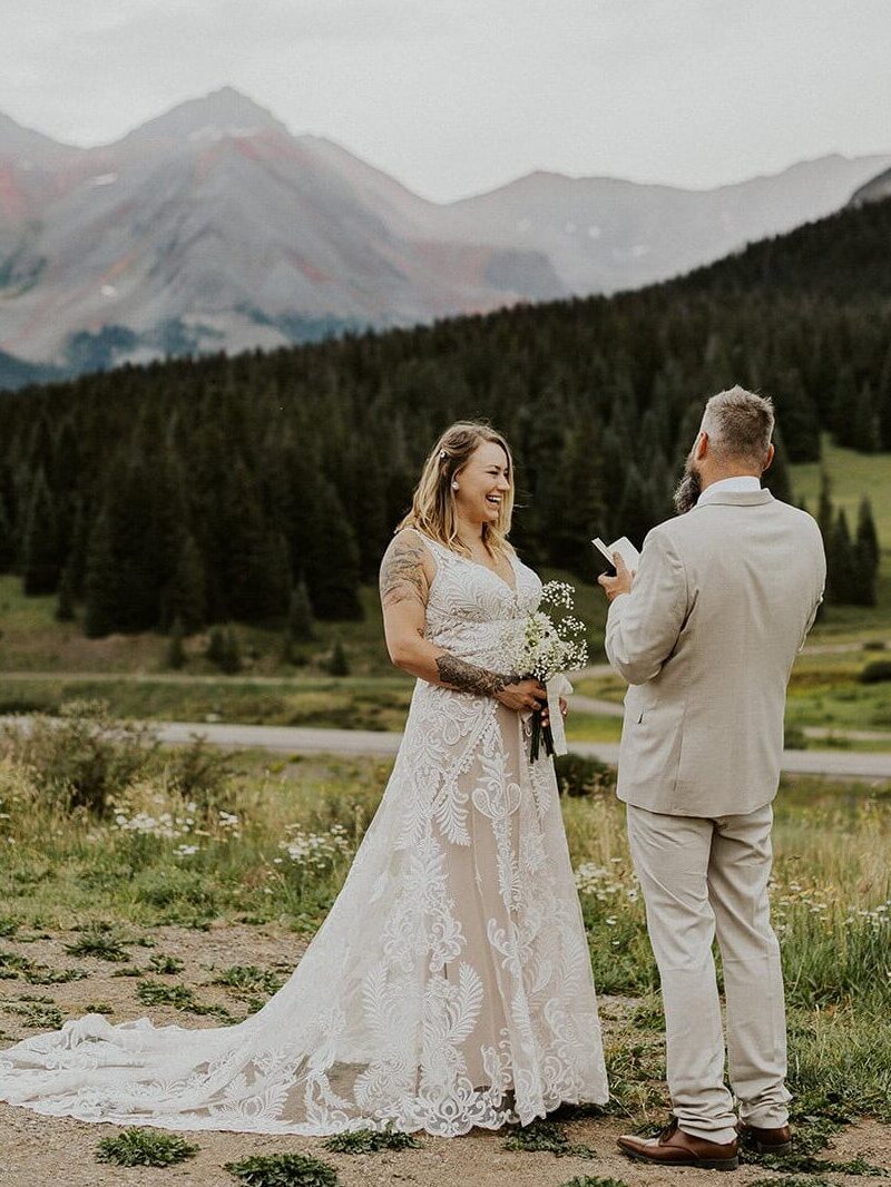 Couple laughing while sharing their vows in Telluride.